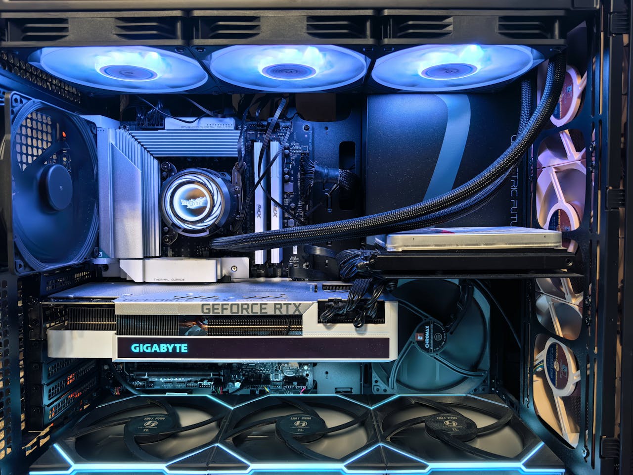 Close-up of an advanced gaming desktop PC with GeForce RTX, liquid cooling, and RGB lighting.